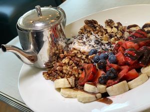Chocolate Quinoa Breakfast Bowl:  Blueberries, Strawberries, Bananas, Toasted Coconut, Walnuts & Pecans drizzled with Dark Chocolate Sauce, served with Oat, Almond or Soy Milk at Anna's House in Kalamazoo