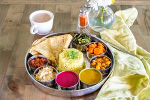 Nourishing Plate -- A kingly, balanced, sattvic, organic, plant-based meal, with all of the day's proteins/vegetable dishes, the soup of the day, and rice pudding.
 at Nourish Wellness Cafe in Costa Mesa