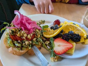 Vegan avocado toast with fruit side at Sunny Point Cafe in Asheville