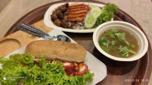Hot dog sandwich and red pork with rice at So Vegan - Gateway Ekkamai in Bangkok