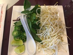 Basil, lime and sprouts for the pho  at vPho in Newark