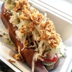 Jumbo Bratwurst hot dog with Pretzel bun, Swedish mustard, local made Dill Sauerkraut and crispy onion at Dauns in East London