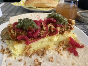 Vegan seitan sausage, mash, ketchup, mustard, picked onions, cucumber relish and crispy onions  at Dauns in East London