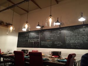 The restaurant view with the blackboard with day specials  at Mezé Bistrot in Rome
