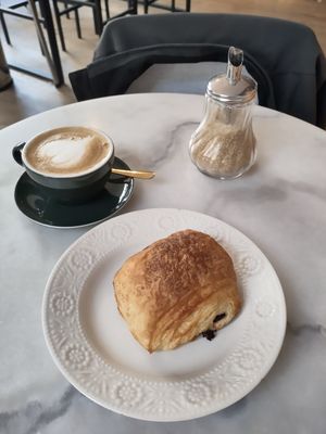 Pain chocolat and a flat white at L'Alchimiste in Brussels