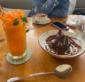 Brownie with pistache ice cream, capuccino with oat milk and fresh juice  at Wild Cafe in Estepona