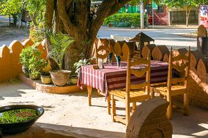 Outdoor seating under the tree. at 7 Sisters Restaurant in Bagan