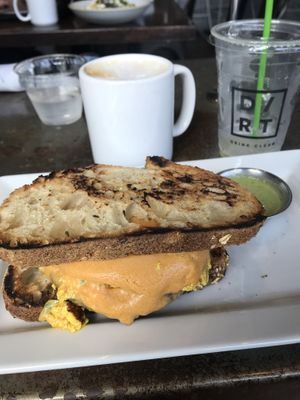 Cappuccino with house-made nut milk + breakfast sandwich at Dirt - Bay Rd in Miami Beach