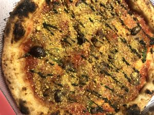 Vegan pizza with vegan parmesan  at The Dainty in Chamonix-mont-blanc