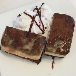 Ginger chai ice cream sandwich (sliced for sharing) with coconut cream at Ananda Fuara in San Francisco