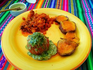 Stuffed roast tomatoes with tarwi pesto and pecans,  sweet potatoes in mandarin honey and sautéed sweet onion and green papaya.  at Pachamama Health in Veracruz