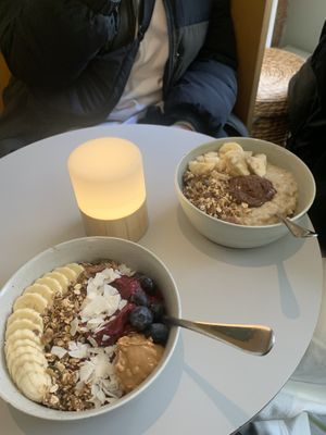 Acai blueberry bowl and oat porridge with toppings  at GRØD in Aarhus
