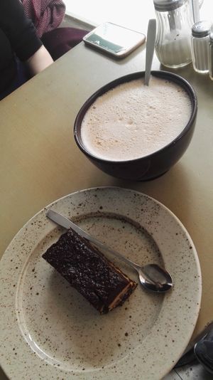 Vegan options: peanut butter and cocoa brownie and oatmilk chai latte at Café 60 in Stockholm