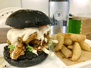Black magic mushroom burger, comes with slaw on the side and potato wedges   at Blue in Penang