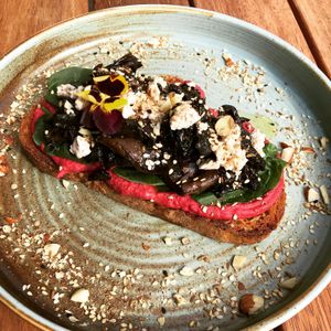 Garlic and thyme mushrooms, spinach, almond feta. beet hummus with a sprinkle of dukkah. at Love Madre in Cheltenham