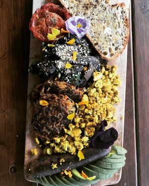 Big Madre Breakfast: tomato, garlic mushrooms, spinach, scrambled tofu, rostis, Italian sausage, avocado at Love Madre in Cheltenham