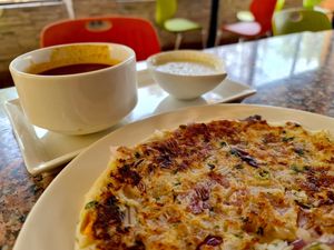 Onion Uttapam with two sauces, The home-made coconut dip is delicious. at Windmill in Nairobi