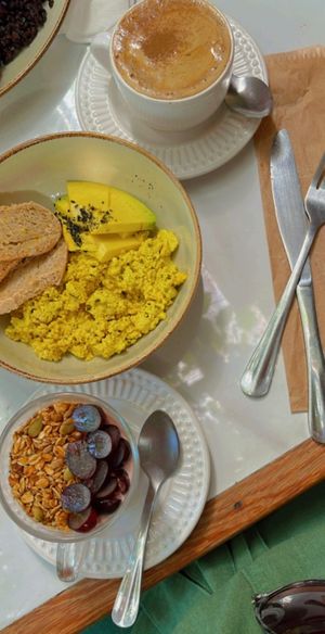 Vegan yogurt, toasts with scrambled tofu and avocado and coffee latte  at Alimentos da Vila in Salvador