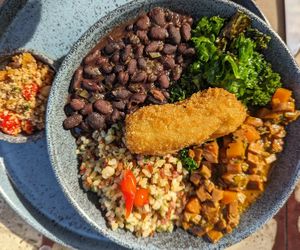Beans, pea protein, kale and rice with farofa at Banana Verde in Sao Paulo