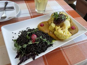 Cauliflower steak with date paste, sweet potato purée and beluga lentils with pickled onion  at Forgó Étterem in Dunabogdany