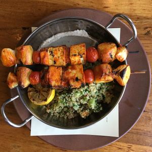 Hodo Soy Tofu Brochettes, cherry tomatoes, yam, fingerling potato, cippollini onions, quinoa, diced cucumbers, tomatoes, pickled red onion tabbouleh, roasted garlic cashew tahini at Greens Restaurant in San Francisco