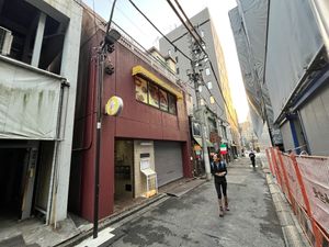 Look for the red/brown building with the small yellow awning    at Loving Hut in Tokyo