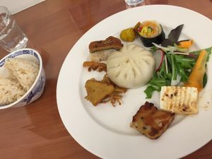 Buffet round 1: "pork" bun, tempura enoki, tempura shiso, tempura sweet potato, "unagi" on rice, potato, spring roll/sushi thing, salad, miso tofu, radish cake, rice (tea and soup not pictured) at Loving Hut in Tokyo