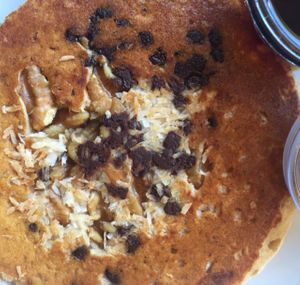 side of trail mix pancake up close: coconut, chocolate chips, walnuts at Herbivore - Mission District in San Francisco