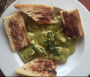 ravioli with basil pesto sauce: filled with artichoke and spinach and served with garlic bread. $12.75 comes with side salad.  at Herbivore - Mission District in San Francisco