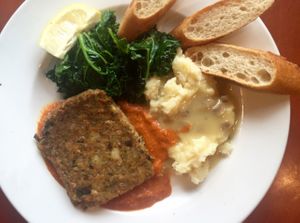 quinoa cake entree: roasted red pepper sauce, mash potatoes and mushroom gravy, sautéed kale and crostini. contains walnuts. $13.75 at Herbivore - Mission District in San Francisco