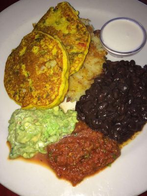 Corn cakes, black beans and hash brown - with guacamole and salsa. It was good. at Herbivore - Mission District in San Francisco