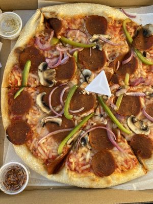 Vegan cheese, pepperoni, peppers, onions, and mushrooms with a side of nooch! at Americana Pizza in Boise