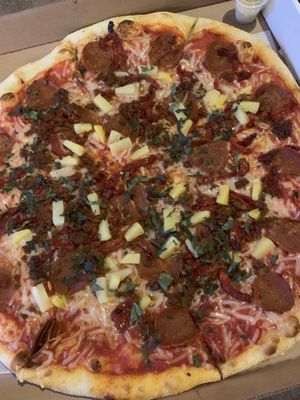 Vegan cheese, sausage, pepperoni, sun dried tomatoes, pineapple pizza at Americana Pizza in Boise
