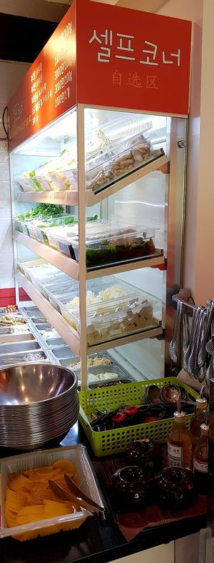Buffet for selecting ingredients, next to pickled radish (free side dish) and dipping sauces at Sonogong Maratang 손오공 마라탕 - Hongdae in Seoul