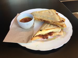 Sausage, sauerkraut and hashbrown jaffle with chutney at For Change Cafe - Melbourne Uni. in Parkville