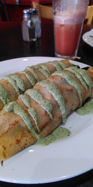 Vegan Mediterranean crepes, rainbow juice in background - yummy at The Lillipad Cafe in Cairns
