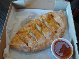$12.45 Vegan Calzone with Vegan mozzarella, vegan feta, olive oil, garlic, oregano, marinara and a side of marinara at Zito Pizzeria and Grill in Winston-salem