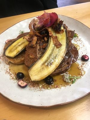 Vegan French toast with coconut bacon, blueberries (fresh and freeze dried) as well as edible flowers  at Gratitude in Tauranga