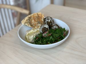 Hummus bowl with falafel, tabouli, pickles and pita at Colours Bowls in Prahran