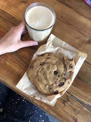 Iced oat milk latte, salted vegan chocolate chip cookie. at Honest Greens - Plaça Catalunya in Barcelona