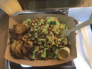 Vegan chickpeas with jollof rice and coconut sauce and plantain. Absolutely delicious!!! So tasty. And really good value for money.   at Osè African Cuisine in Paris