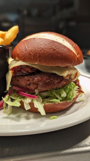 Chargrilled premium burger top with pulled pork from redefine meat at VGN Boulevard in Stourbridge