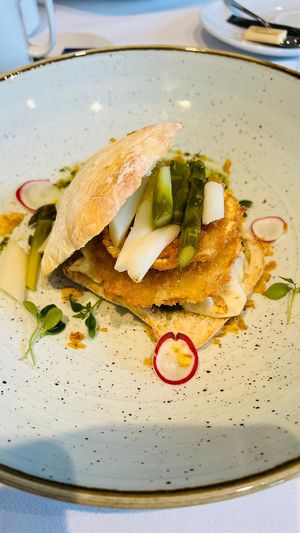 A burger with a celeriac patty and pesto and asparagus and also thinly sliced raw celeriac(marinated)  at Bahnhöfli in Haag