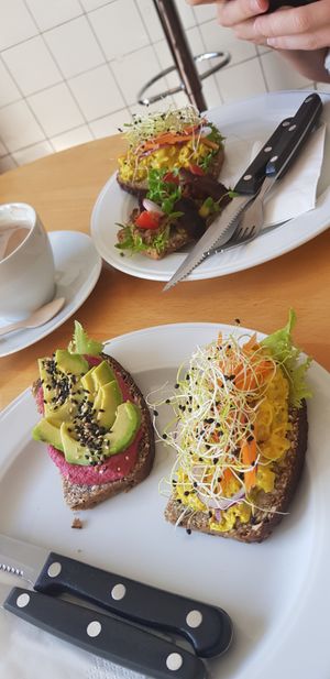 Left: beetroot hummus + avocado; Right: Chickpea salad + pickled carrots, both served on a type of whole wheat bread at Lillians Smørrebrød in Copenhagen