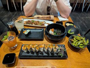 From top to bottom left to right: basil-lime mojito, mai tai, the wedge specialty roll, cucumber maki, point reyes specialty roll, agedashi tofu, garlic edamame at Tane Vegan Izakaya in Honolulu