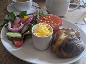 Jacket potato with vegan cheese at The Secret Garden in Dorchester