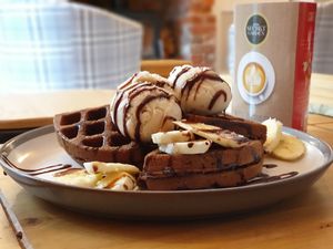 Chocolate Waffles served with banana, vegan ice cream and chocolate sauce. Vegan/Gluten free waffles also available. at The Secret Garden in Dorchester