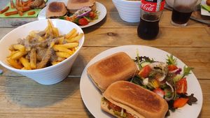 Poutine side dish and tomato, pesto and mozzarella panini at The Secret Garden in Dorchester