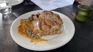 Amuse: housemade focaccia, carrot spread, za'atar oil, ras el hanout marinated olives, gigante bean, fennel & caper salad  at Millennium in Oakland