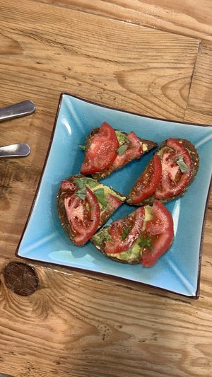Toast with avocado and tomato and fresh herbs   at Izzy's Market Vegetarian Boutique in Vila Do Bispo